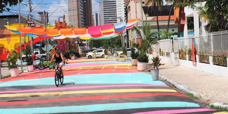 Woman on bicycle in Fortaleza Woman on colorful street in Fortaleza
